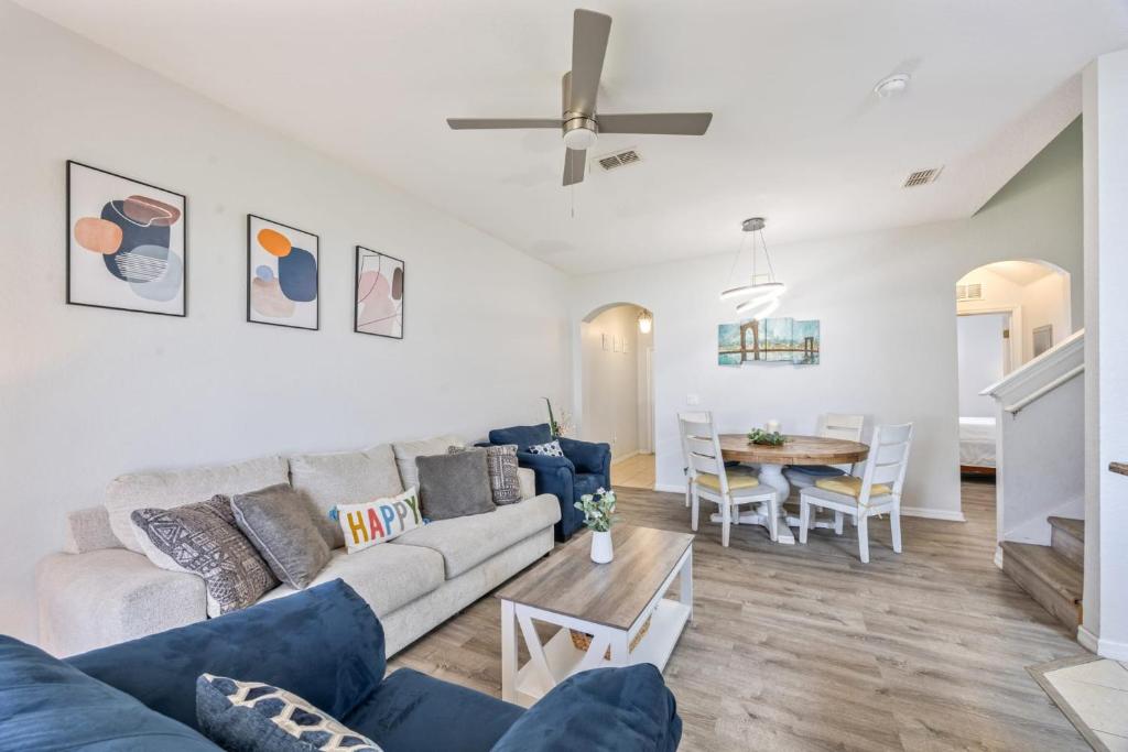a living room with a couch and a table at Cozy Stylish Townhome in Davenport