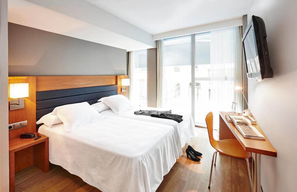 Postel nebo postele na pokoji v ubytování Barcelona Century Hotel