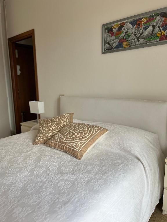 a white bed with a pillow on top of it at novarasanmartino22 in Novara