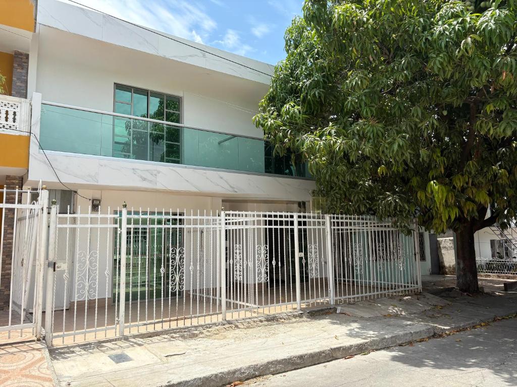 a white fence in front of a building at Almaré apartamento en Cartagena in Cartagena de Indias