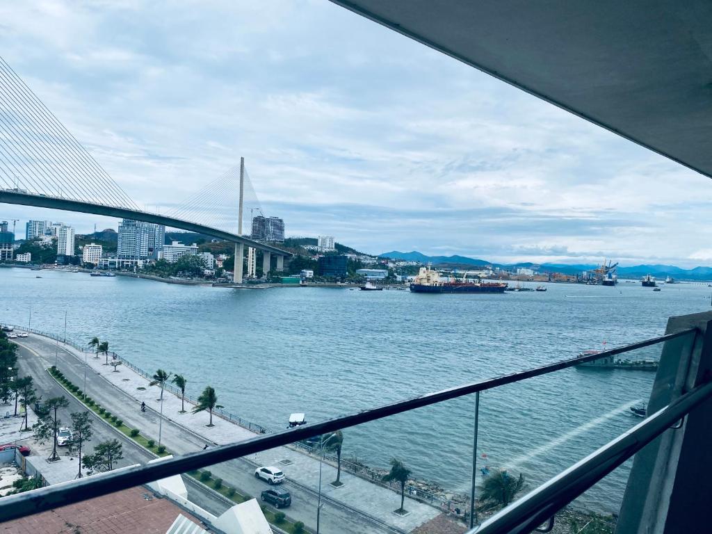 a view of a river from a balcony with a bridge at Green Diamon Luxury Apartment in Ha Long
