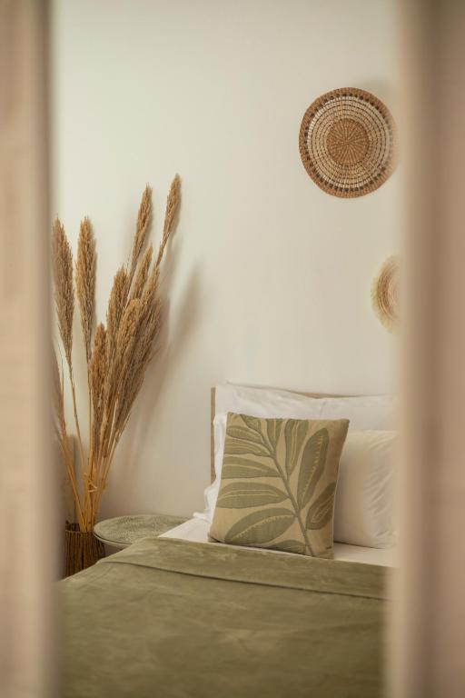 a bedroom with a bed with a pillow and plants at Villa Shafeti in Ksamil