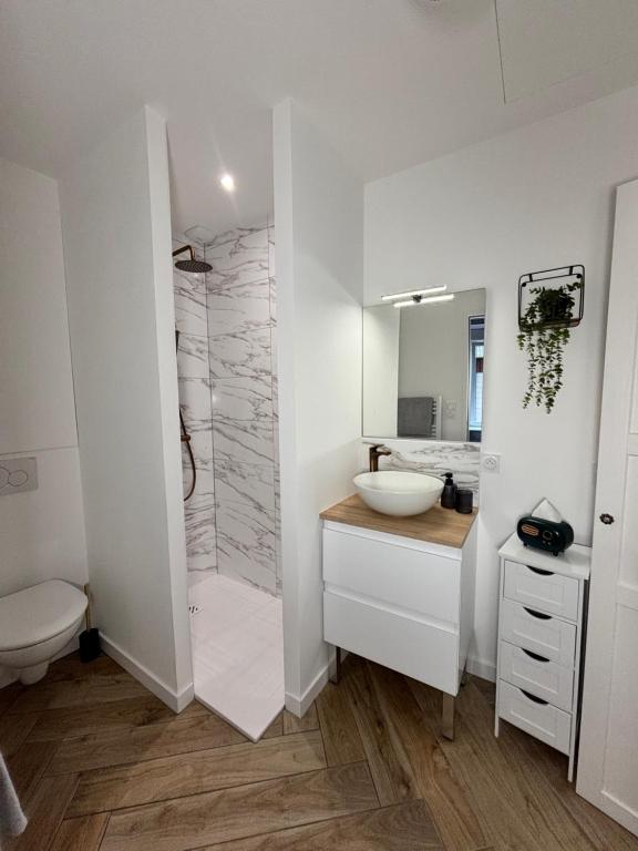 Un baño con ducha, lavabo e inodoro. en Le Little Italy, en Cholet