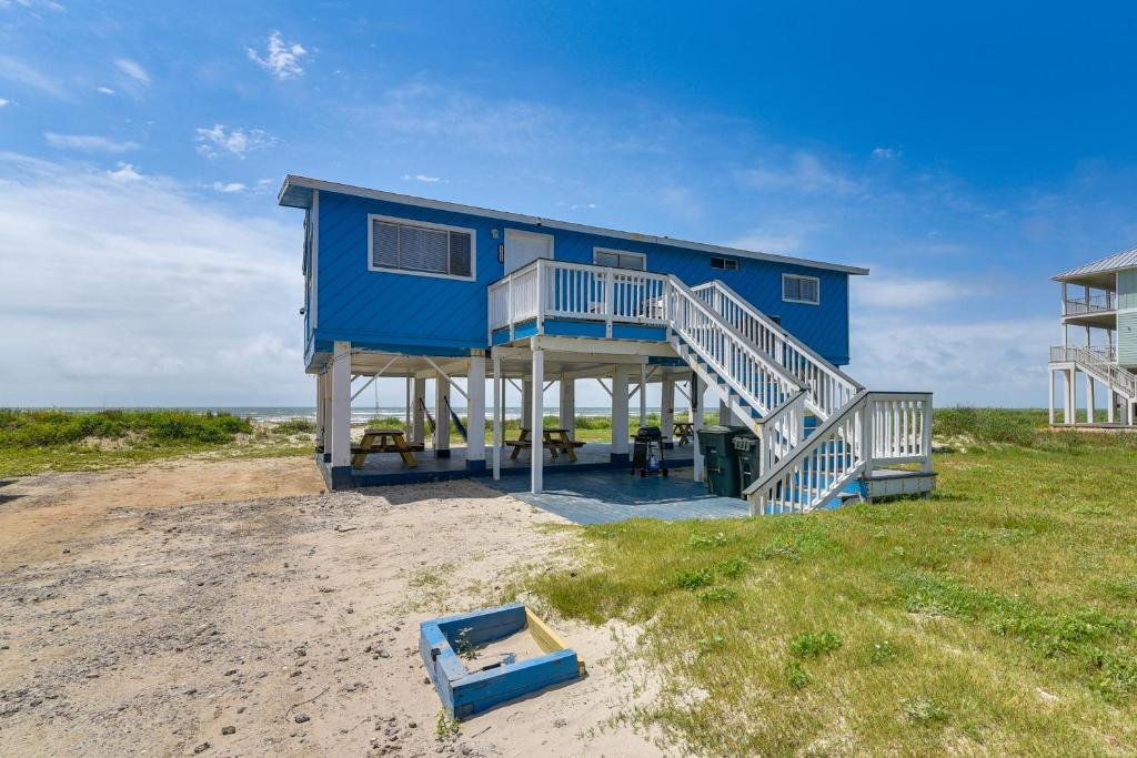 a blue house on the beach next to the ocean at Oceanfront Galveston Home on Terramar Beach in Galveston