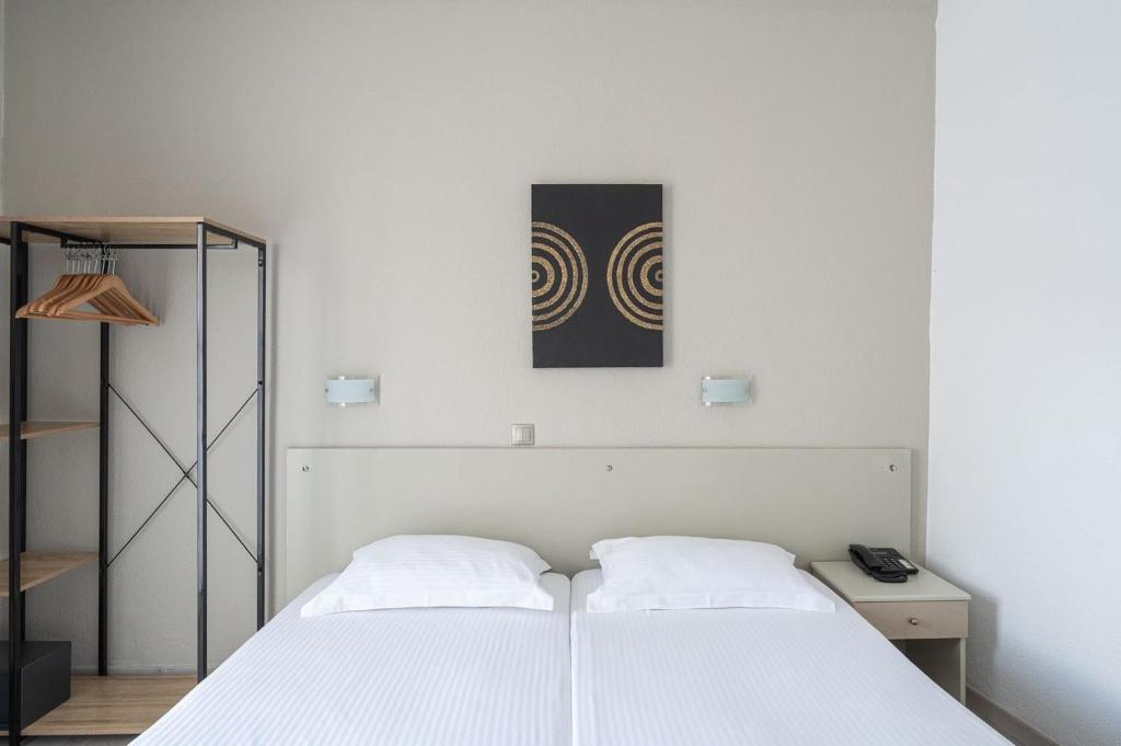 Postel nebo postele na pokoji v ubytování Hotel Akropol