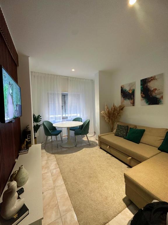 a living room with a couch and a table at Luxury home in Amora