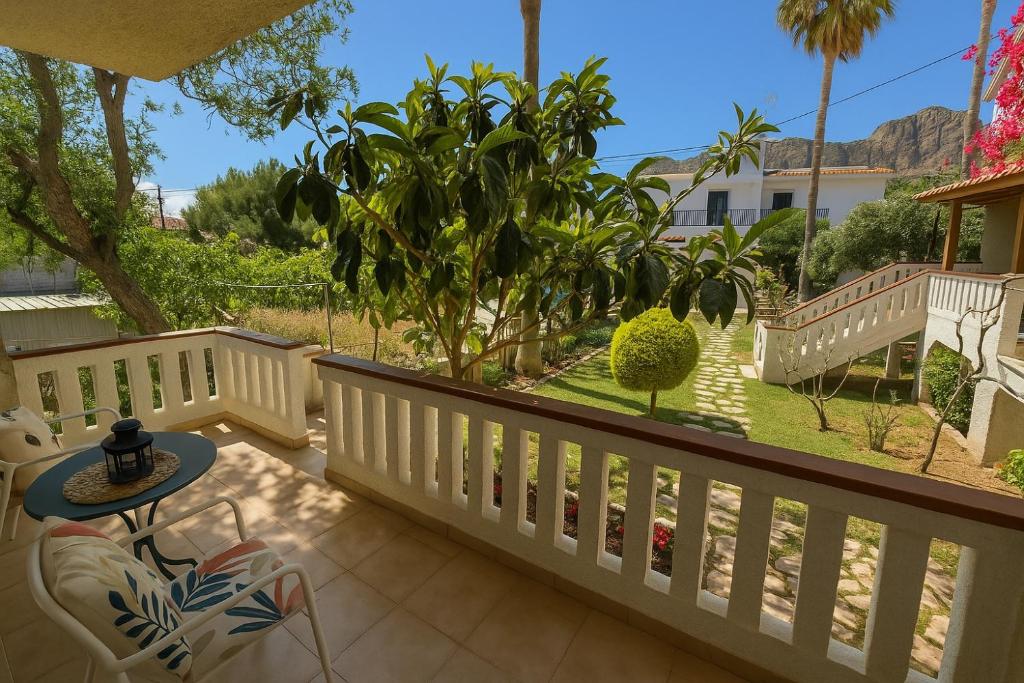 a patio with a table and chairs on a balcony at Nicolas Beach in Palaiochora