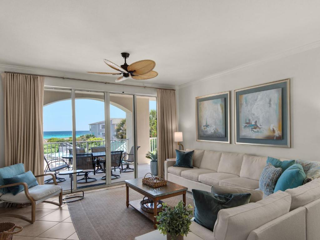 a living room with a couch and a ceiling fan at San Remo Condominium 209 by Newman-Dailey in Santa Rosa Beach