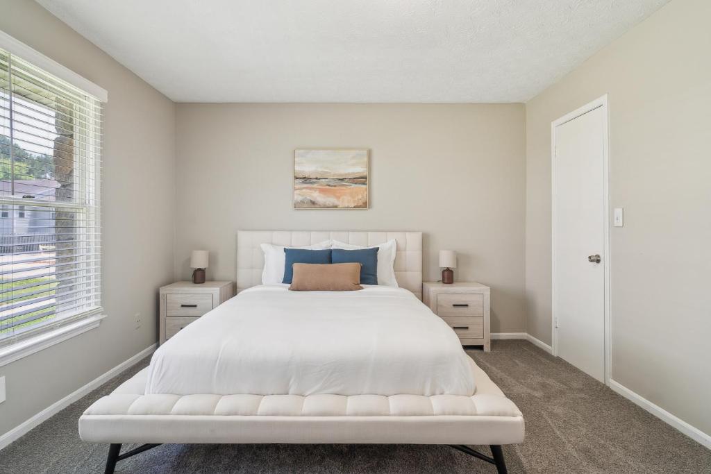 a white bedroom with a white bed and a window at Rex Townhomes 2401a I Comfy 2 Bed 2 Bath in Ellenwood