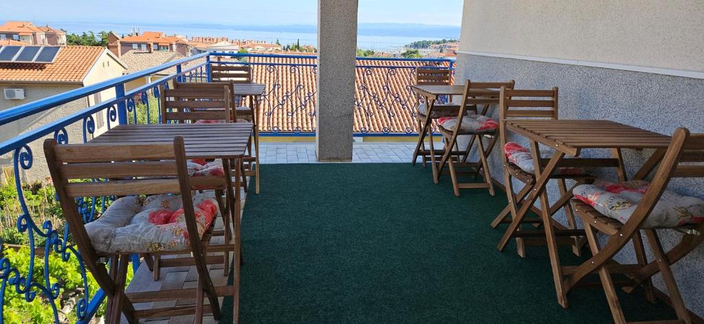 a row of tables and chairs on a balcony at Rooms Laguna Maresol in Jagodje