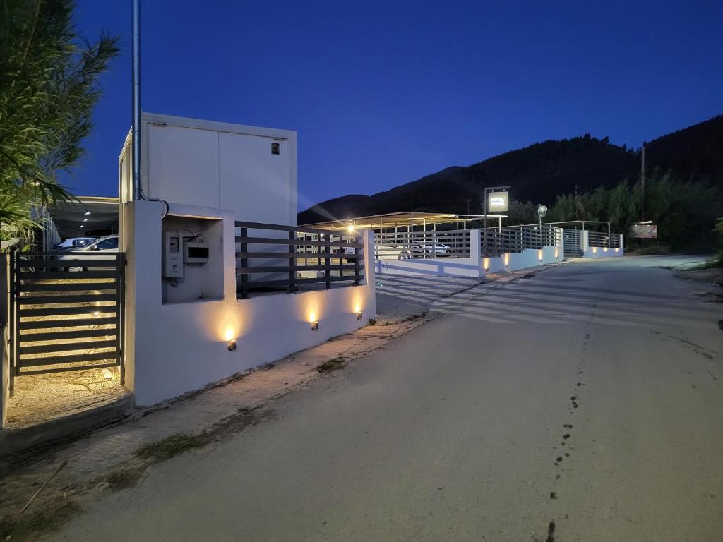 a street with stairs and lights at night at Vourvourou Hotel in Vourvourou