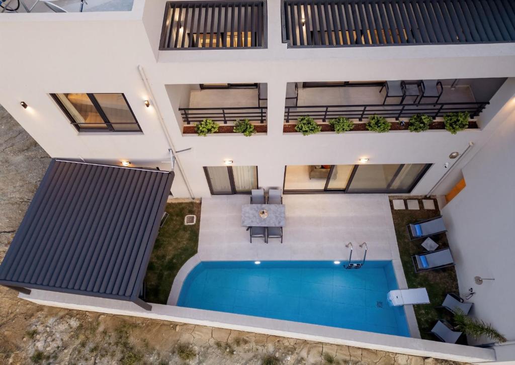 an aerial view of a house with a swimming pool at Plakias Seaside Residences - Ortansia in Plakias