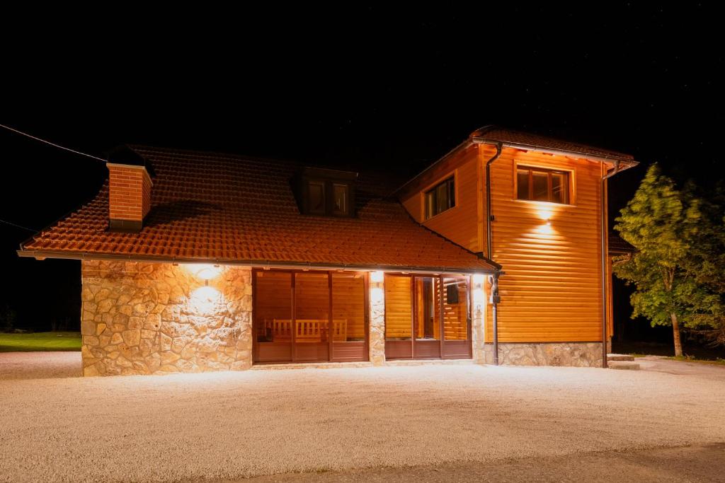 a house with a garage at night with lights at Kuća za odmor Roko in Sveti Rok