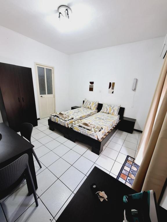 a bedroom with a bed and a desk in it at Lovely Paceville Studio G in St. Julianʼs