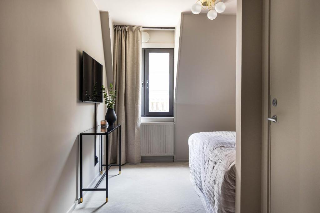 TV a/nebo společenská místnost v ubytování Villa Gutebagge Hotell