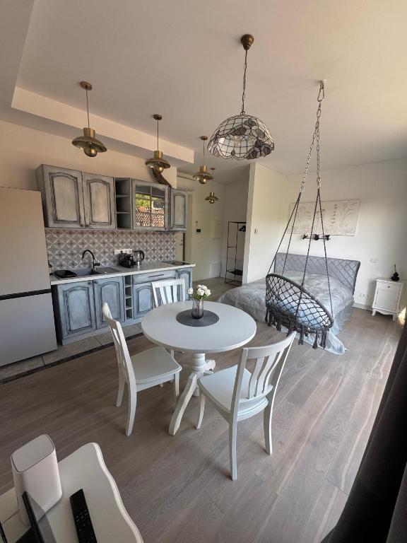 a kitchen and living room with a table and chairs at Cozy Apartment in Vilnius Paupys in Vilnius