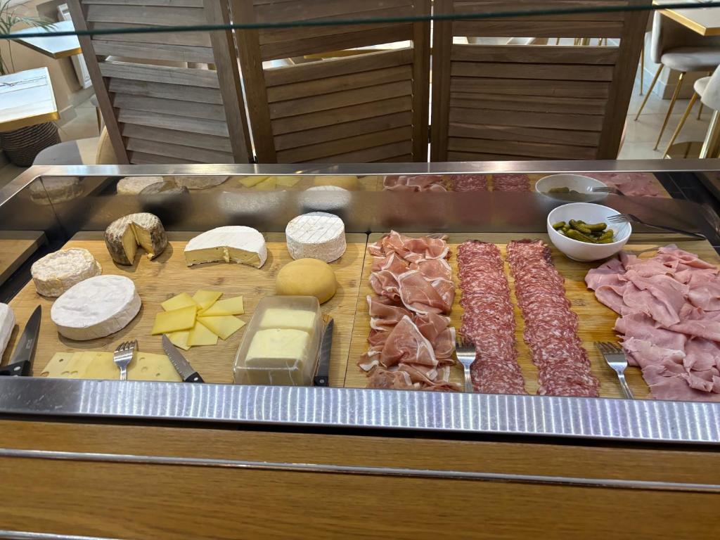 a bunch of meats and cheese on a counter at Hôtel Beau Site - Cap d'Antibes in Antibes