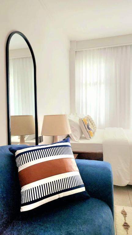 a room with a bed and a pillow and a blue couch at Peache house in Ruaka