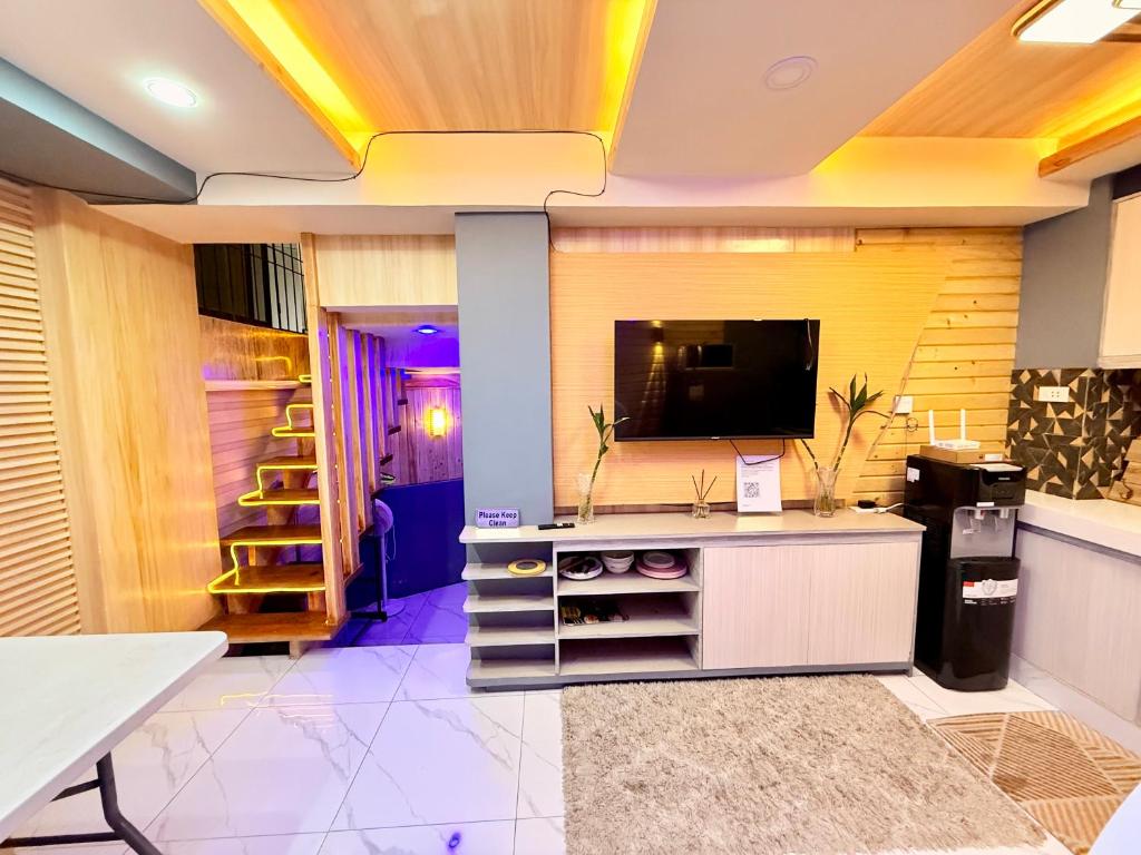 a living room with a flat screen tv on a wall at 3BR Across Burnham Park Baguio Transient - Unit 23 in Baguio