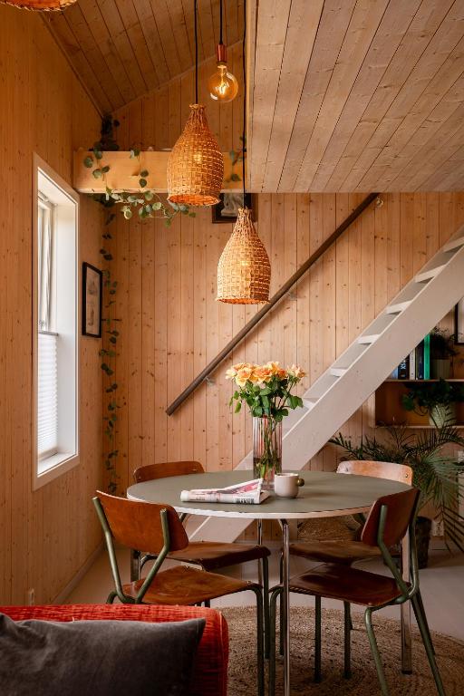 a room with a table and chairs and a staircase at VillaView Cabin in Oslo