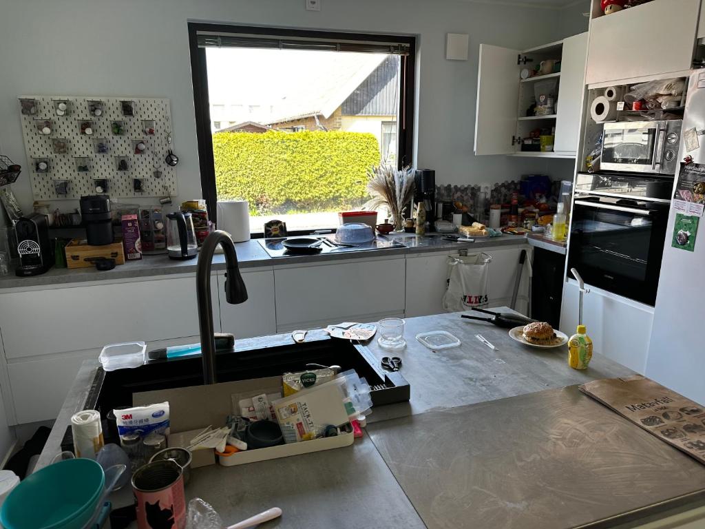 a kitchen with a sink and a counter top at Rum i villa Burlöv in Arlöv