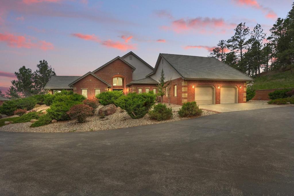 a house with a driveway in front of it at Luxe Villa Expansive Yard Near Rapid City in Rockerville