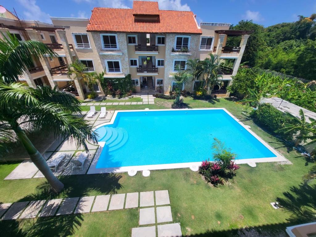 an overhead view of a swimming pool in front of a building at New! Chic Beach Condo at Punta Cana in Punta Cana
