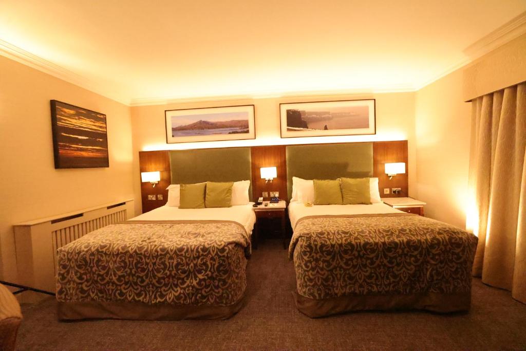 Voodi või voodid majutusasutuse Vaughan Lodge Hotel toas