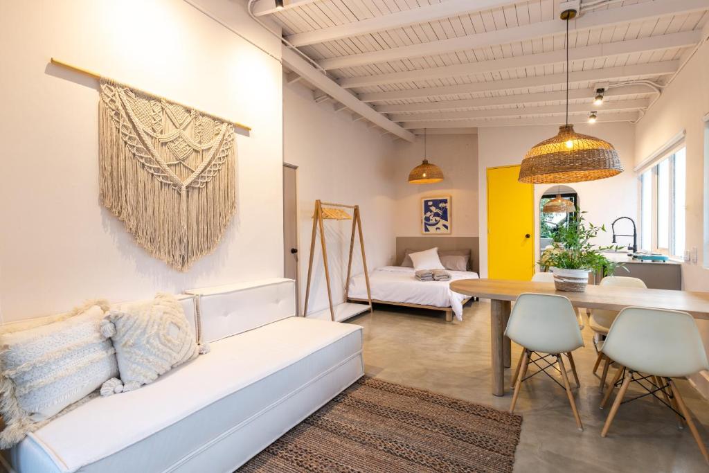 a living room with a white couch and a table at Apartamentos Primavera Manila by HOUSY HOST in Medellín
