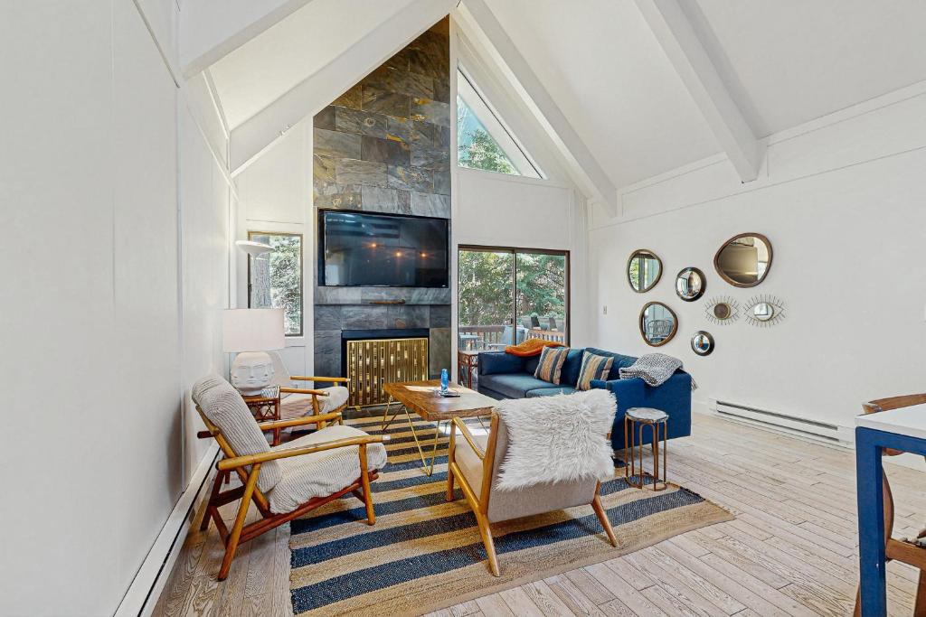 a living room with a blue couch and a fireplace at The Wild Pine Lodge in Incline Village
