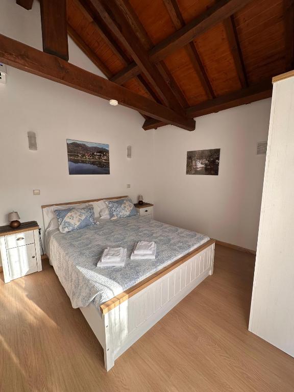 a bedroom with a bed in a room with wooden ceilings at Chalé da Fonte - T2 in Geres