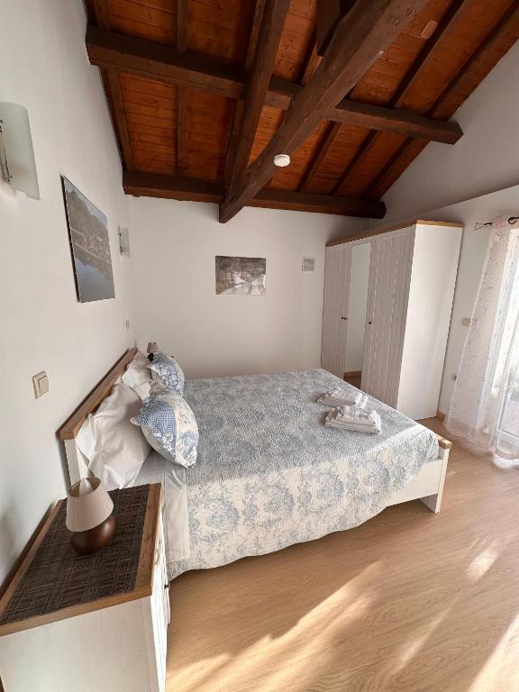 a bedroom with a bed and a wooden floor at Chalé da Fonte - T2 in Geres