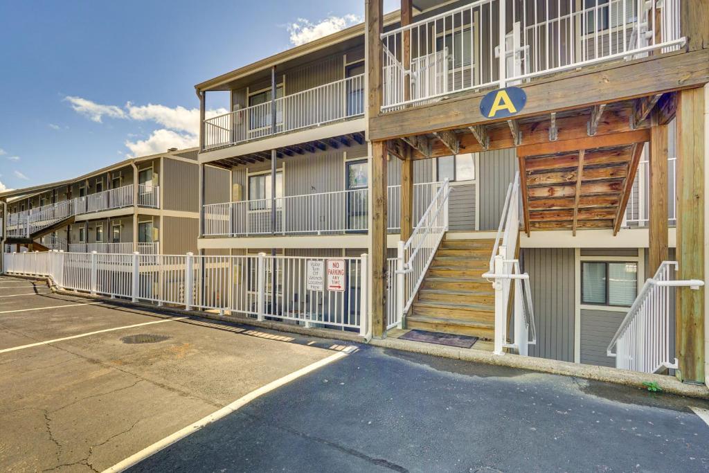 a building with a parking lot in front of it at Lake and Pool Access Lazy Days Condo with Balcony! in Osage Beach