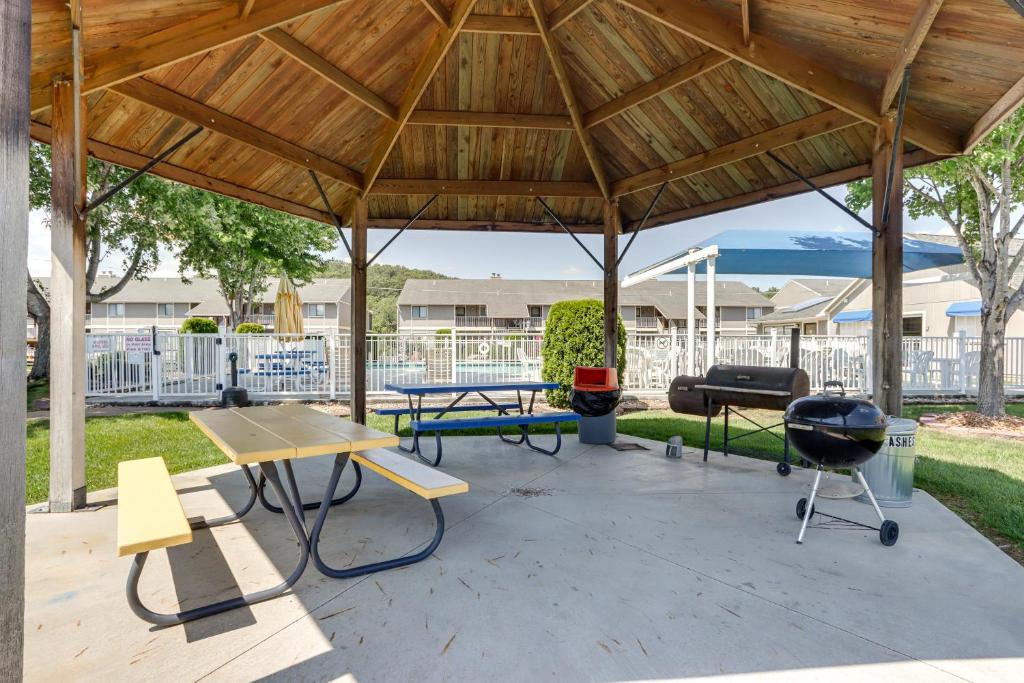 a pavilion with a picnic table and a grill at Lake and Pool Access Lazy Days Condo with Balcony! in Osage Beach