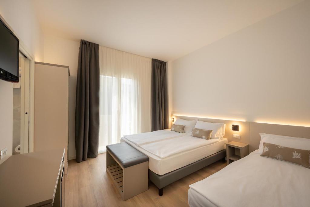 Posteľ alebo postele v izbe v ubytovaní Hotel Delfino