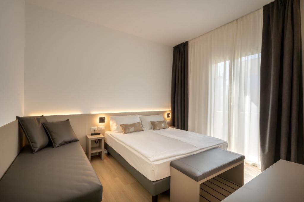 Posteľ alebo postele v izbe v ubytovaní Hotel Delfino