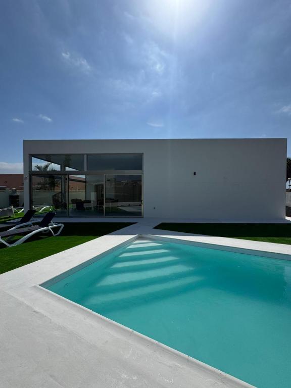 a house with a swimming pool in the yard at Villa Atlantic Breeze in Antigua
