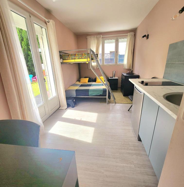 Cette petite chambre comprend des lits superposés et une cuisine. dans l'établissement Chambre lumineuse à 5 min d'Orly, à Athis-Mons