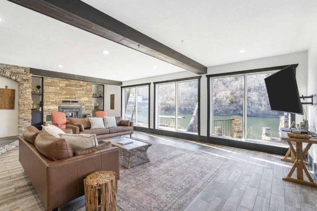 a living room with a couch and a tv at Foggy River Retreat - For 16 in Hollister