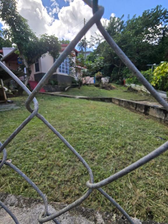 a chain link fence with a yard behind it at Sister Chris' vacation home in Ciceron
