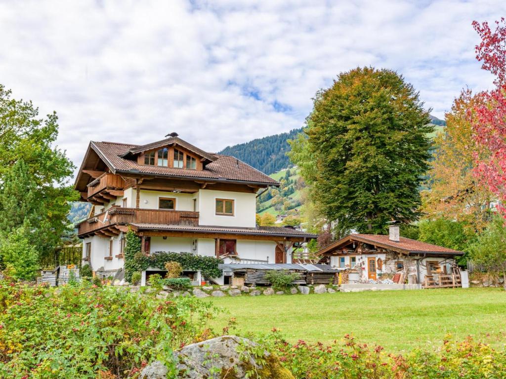a large house in a field with trees at Appartement Brixnerwirt IV in Brixen im Thale