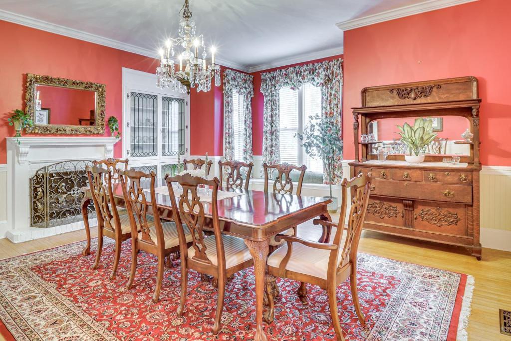 a dining room with red walls and a table and chairs at Walk to Waterfront Downtown Elizabeth City Home! in Elizabeth City