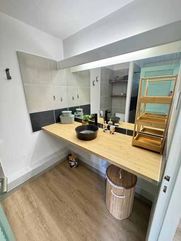 a kitchen with a wooden counter with a sink at Appartement COSY SXM in Cul de Sac