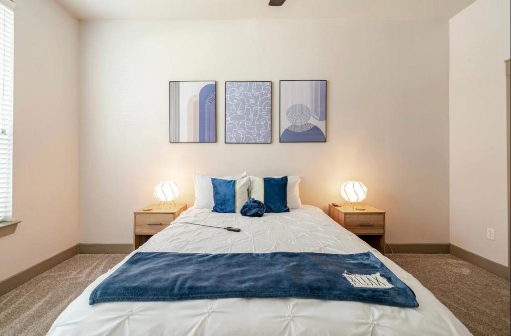 a bedroom with a large bed with blue pillows at Apartment in Downtown Houston Free Parking in Houston