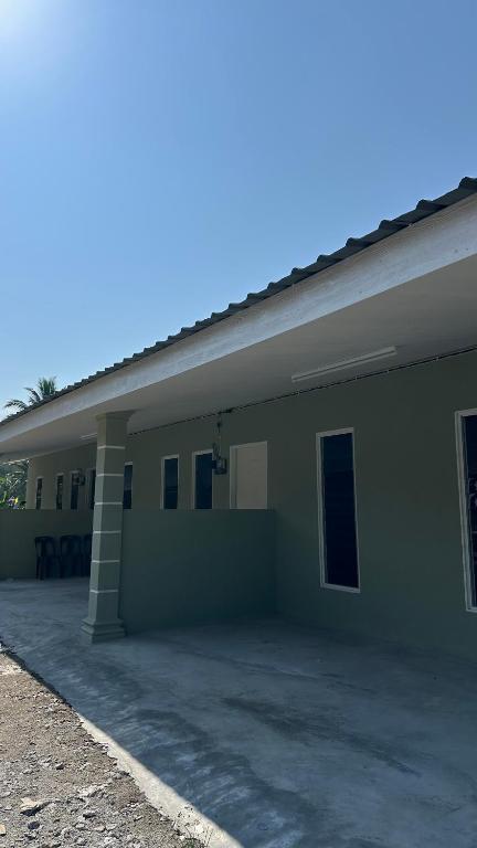 a building with a parking lot in front of it at Baitul Ilmi Homestay in Kuala Kangsar