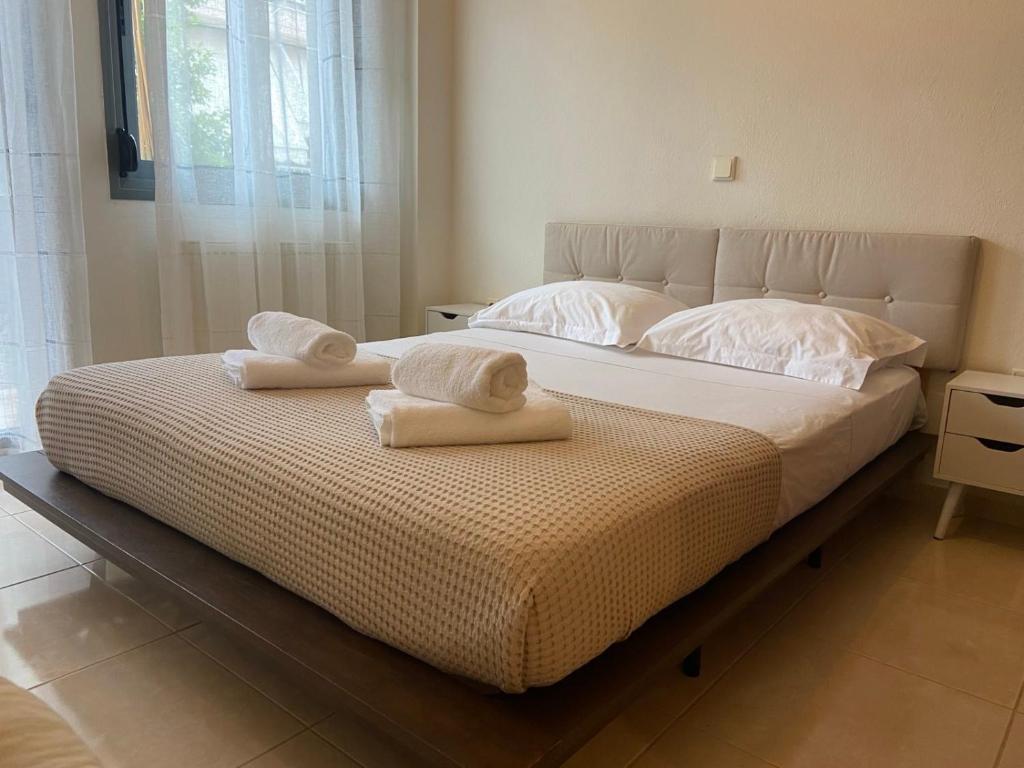 a bedroom with a bed with towels on it at Sofia's Apartment in Nea Moudania