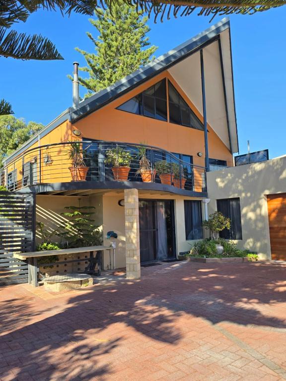a house with potted plants on the front of it at Beach Side Retreat in Lancelin