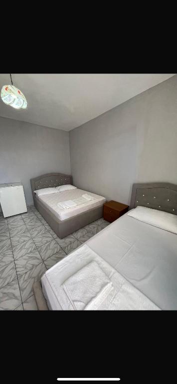 a room with two beds in a room at Hotel Gjika in Sarandë