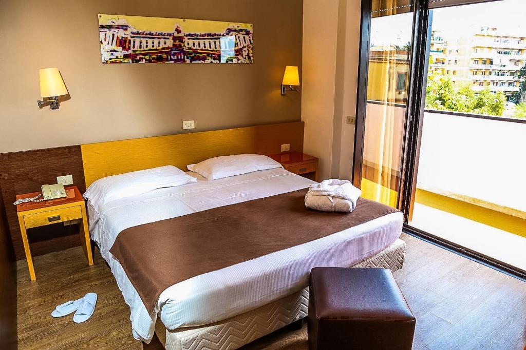 מיטה או מיטות בחדר ב-Hotel Sisto V