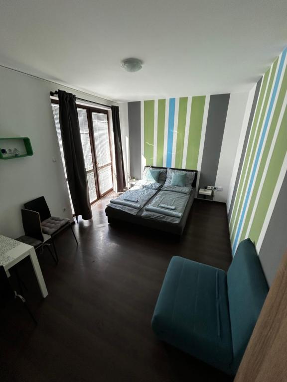 a room with a bed and a couch in it at Lexi Classic 2 in Hajdúszoboszló